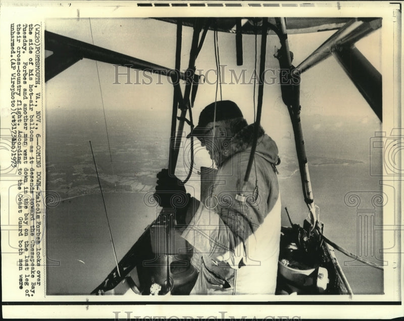 Load image into Gallery viewer, 1973 Press Photo Malcolm Forbes looks over the side of hot-air balloon over bay
