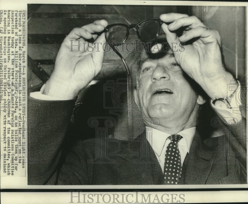 Load image into Gallery viewer, 1966 Press Photo Sen. Fulbright checks his glasses at Foreign Relations hearing
