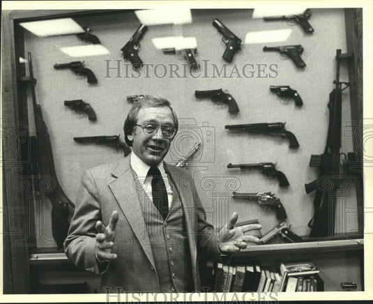 1980 Press Photo Colt Firearms' President C.E.Warner stands in front of display