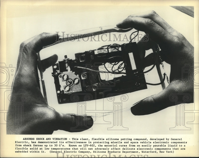 Load image into Gallery viewer, 1961 Press Photo Clear, flexible potting compound absorbs shock &amp; vibrations
