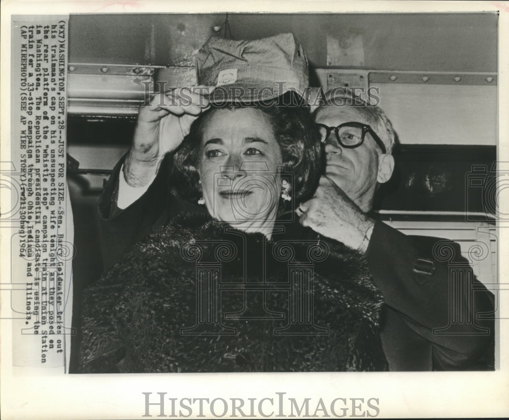 1964 Press Photo Senator Goldwater puts trainman&#39;s cap on his wife&#39;s head