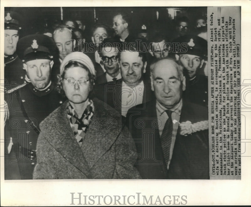 Load image into Gallery viewer, 1961 Press Photo Mrs. Alexei Golub with Soviet officials &amp; Dutch police to plane
