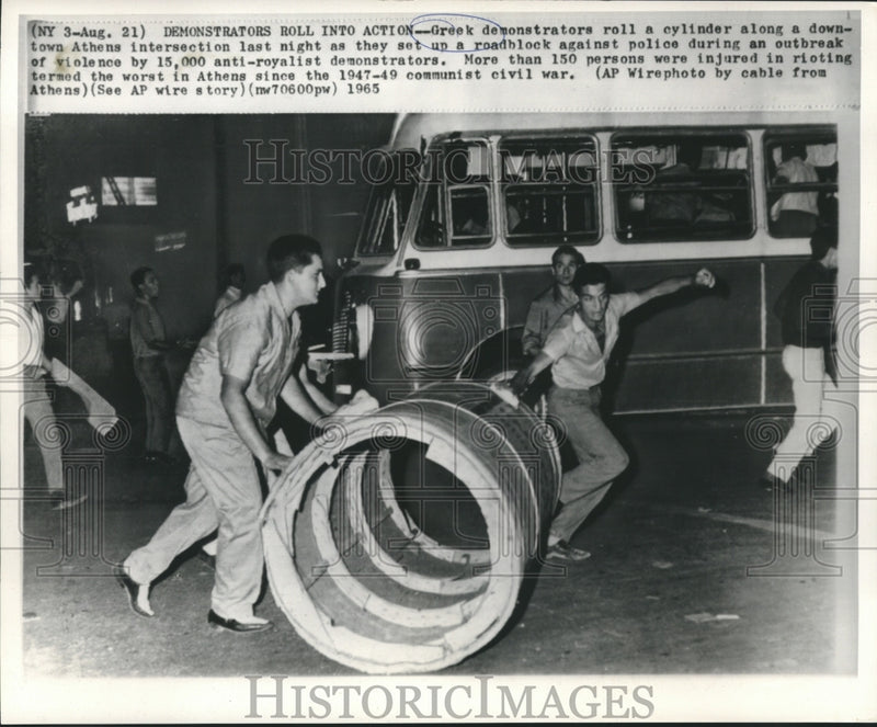 Load image into Gallery viewer, 1965 Press Photo Greek demonstrators roll cylinder as a roadblock in Athens
