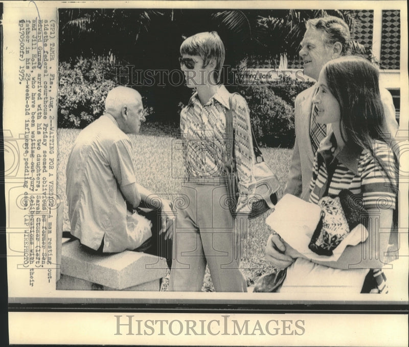 Load image into Gallery viewer, 1975 Press Photo Former Senator Gurney &amp; daughters walk past man on bench
