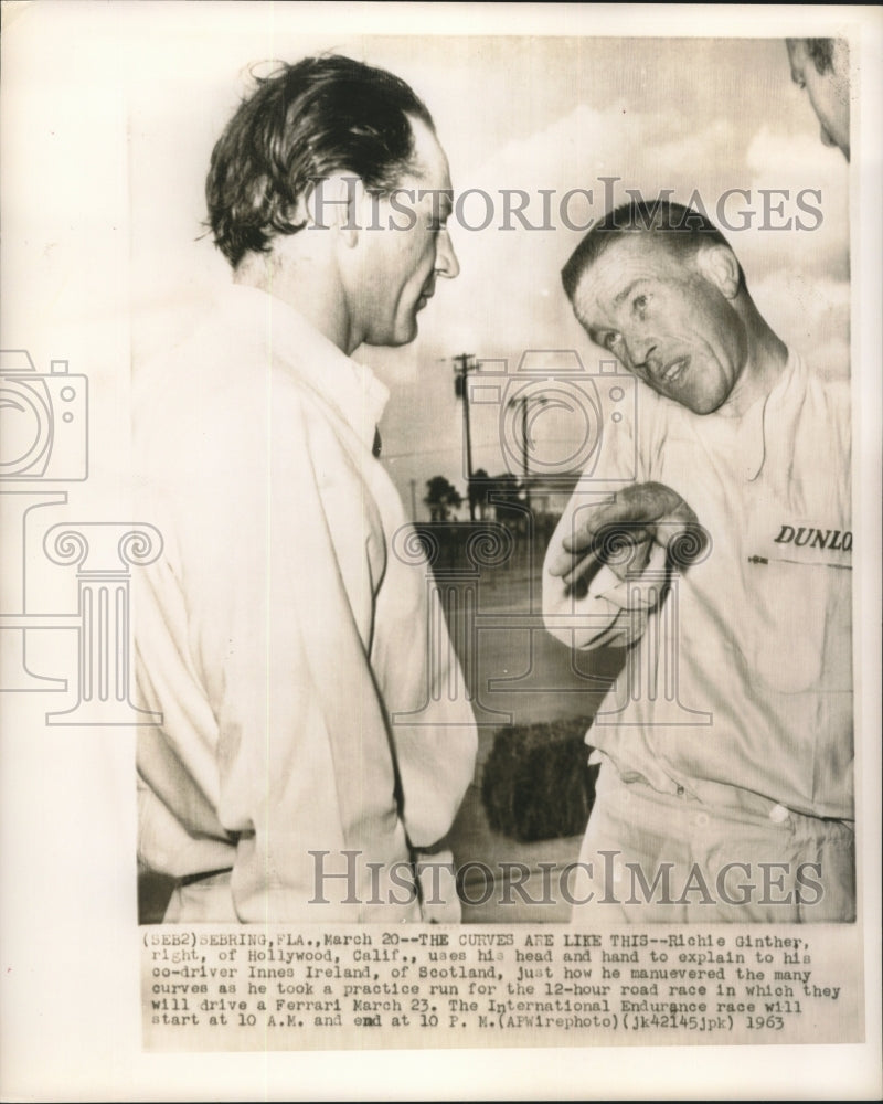 Load image into Gallery viewer, 1963 Press Photo Race car driver Richie Ginther explains curves to Innes Ireland
