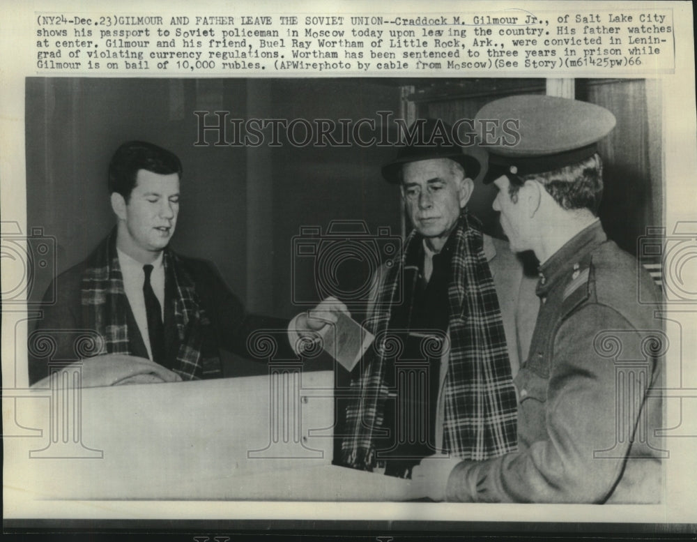 1966 Press Photo Craddock Gilmour, Jr., with father shows passport to Soviet.