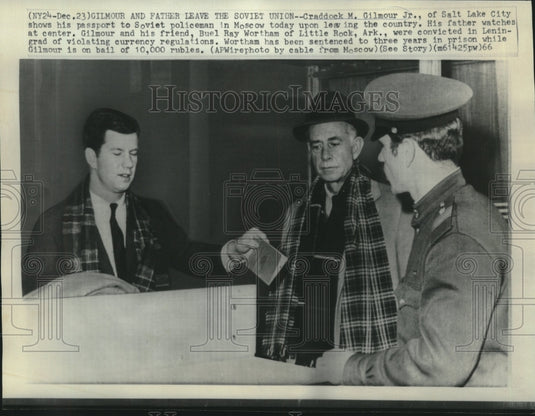 1966 Press Photo Craddock Gilmour, Jr., with father shows passport to Soviet.