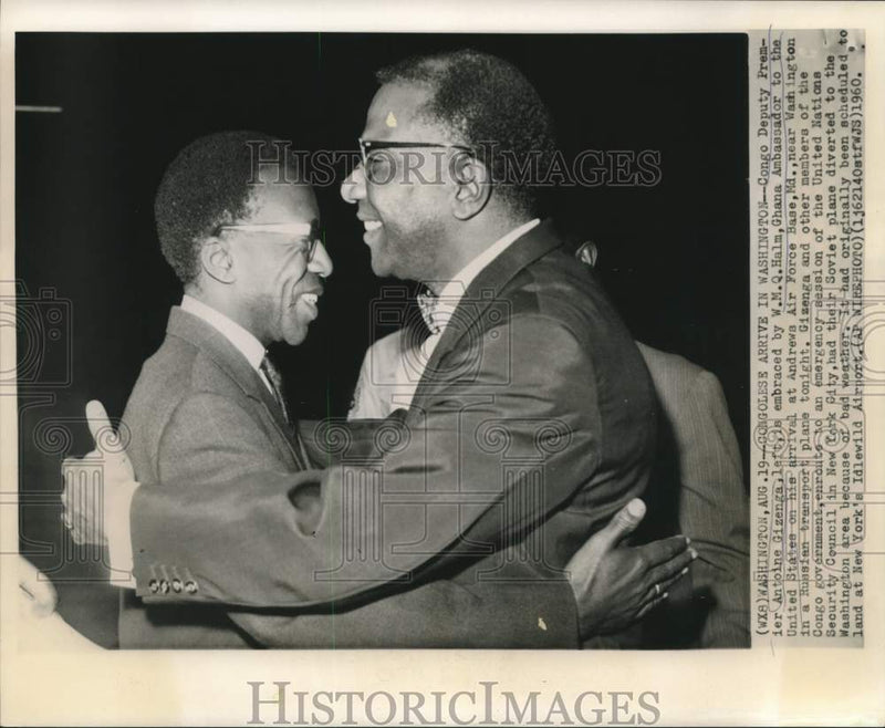 Load image into Gallery viewer, 1960 Press Photo Antoine Gizenga embraced by Halm Ghana at Andrews AFB
