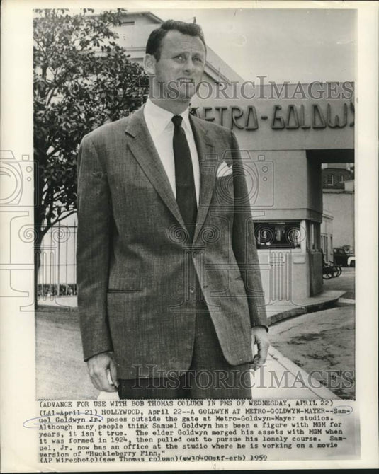 1959 Press Photo Samuel Goldwyn, Jr., poses at gate of Metro-Goldwyn-Mayer in CA