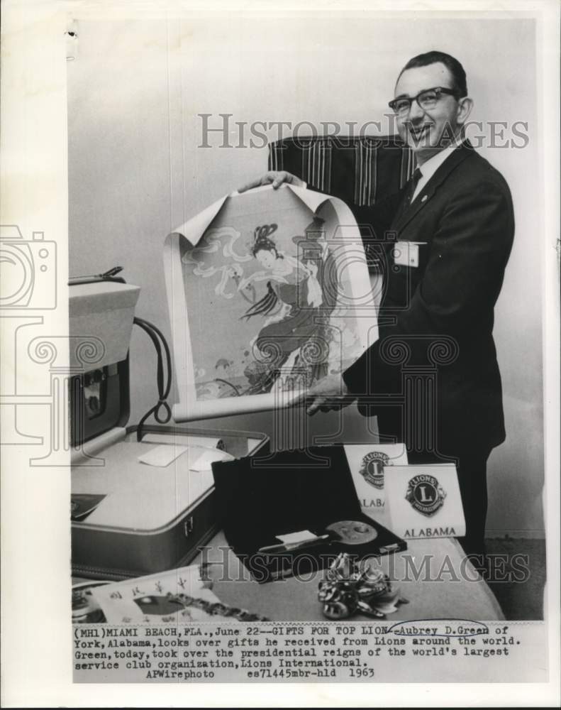 Load image into Gallery viewer, 1963 Press Photo Aubrey Green with gifts received from Lions Club organization
