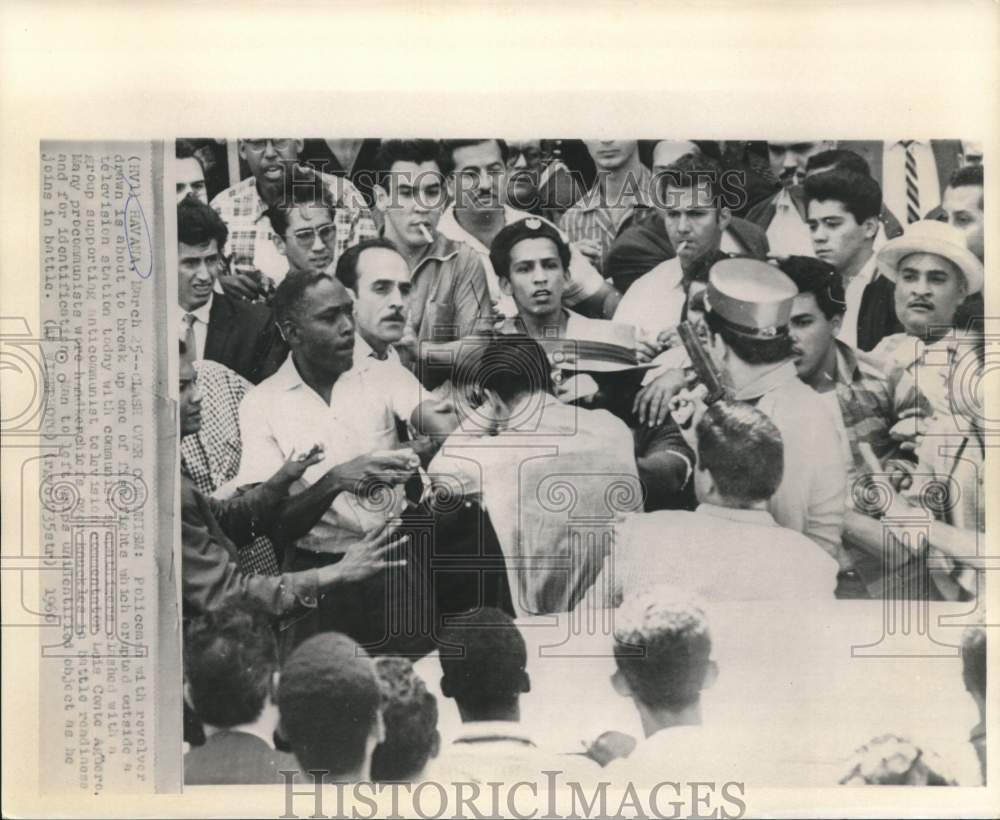 1960 Press Photo Policeman breaks up fight at Cuban television station in Havana