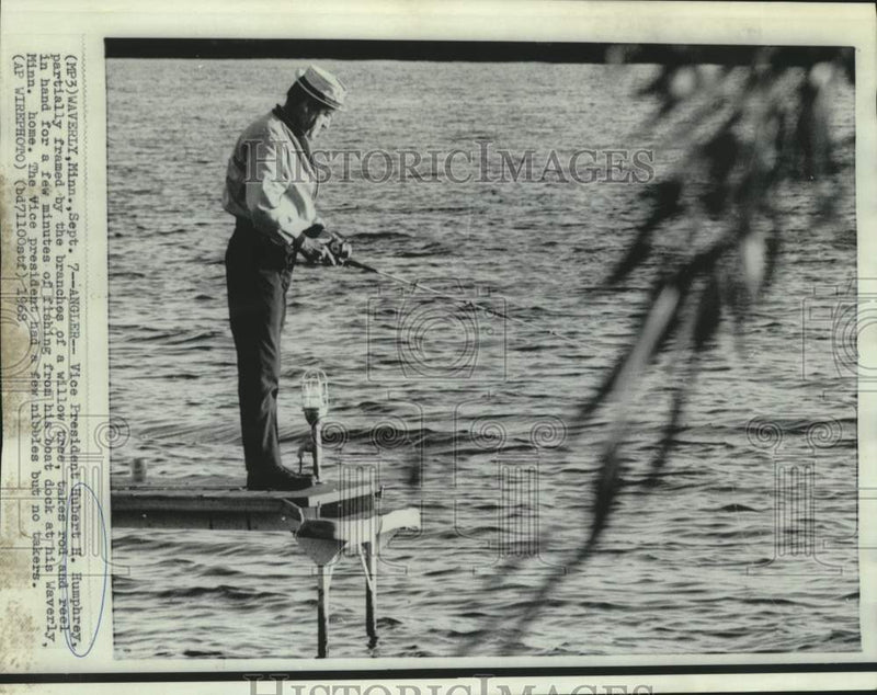 Load image into Gallery viewer, 1968 Press Photo Vice President Humphrey fishes from dock of his Minnesota home
