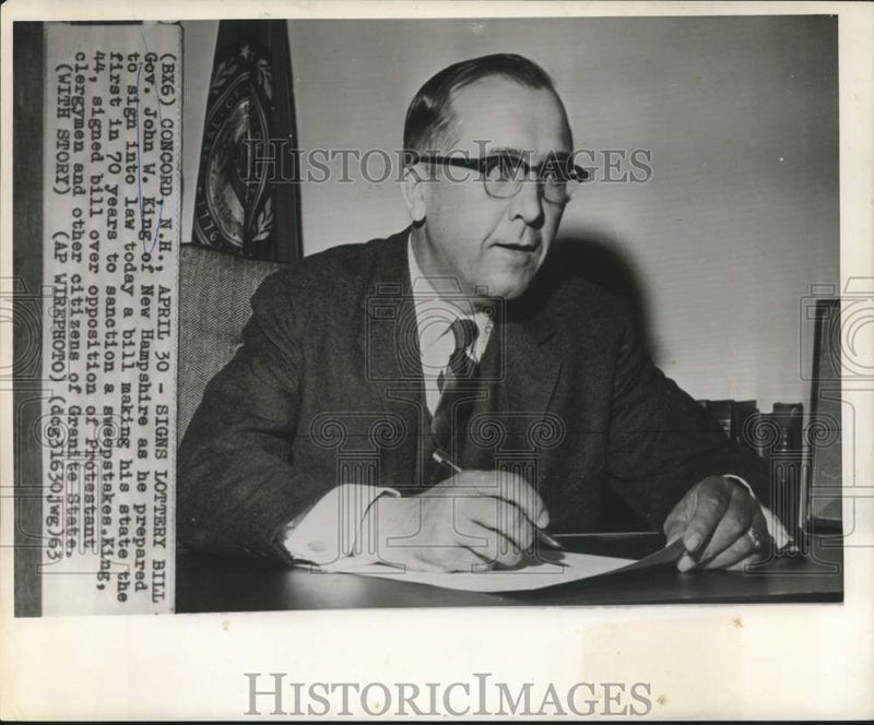 Load image into Gallery viewer, 1963 Press Photo New Hampshire Governor John W. King signs lottery bill.
