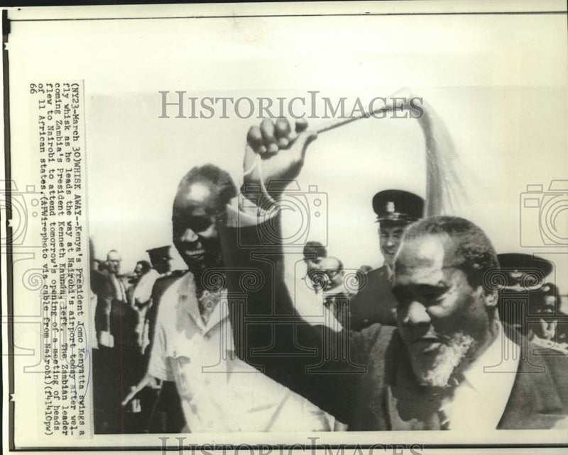 Load image into Gallery viewer, 1966 Press Photo Kenya President Kenyatta swings whisk greeting Zambia's Kaunda.
