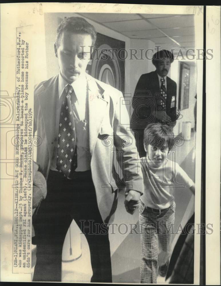 1974 Press Photo Kidnapped George Kaloyerskia escorted by FBI agent onto plane.
