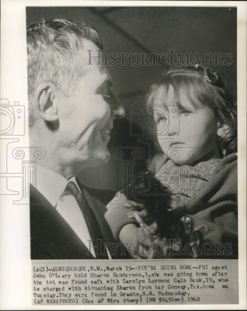Load image into Gallery viewer, 1962 Press Photo Kidnap victim Sharon Henderson held by FBI agent John O'Leary
