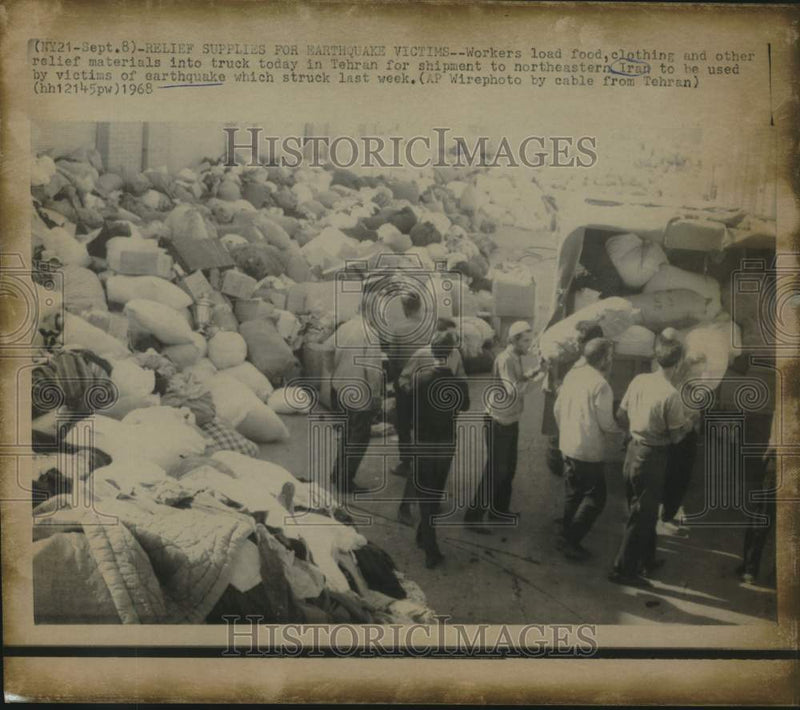 Load image into Gallery viewer, 1968 Press Photo Workers load relief supplies for victims of earthquake in Iran
