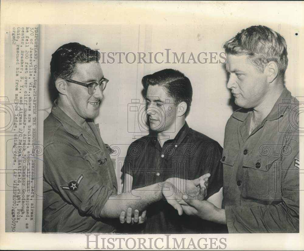 1962 Press Photo Ray Ivarson and rescuers view bruised arm after 200 foot fall