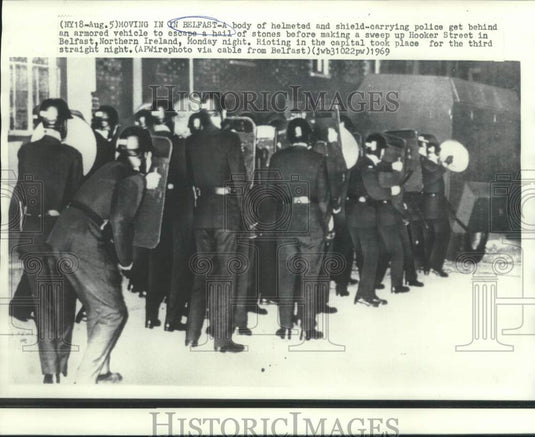 1969 Press Photo Helmeted and shielded police behind armored vehicle in Belfast