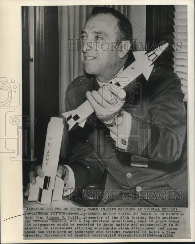 1965 Press Photo Major General Andrew Loll holds rocket model - now17542