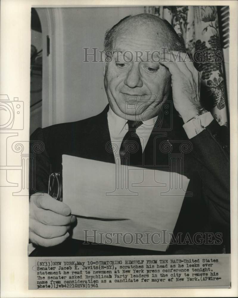 Load image into Gallery viewer, 1961 Press Photo Senator Jacob Javits looks over press conference statement
