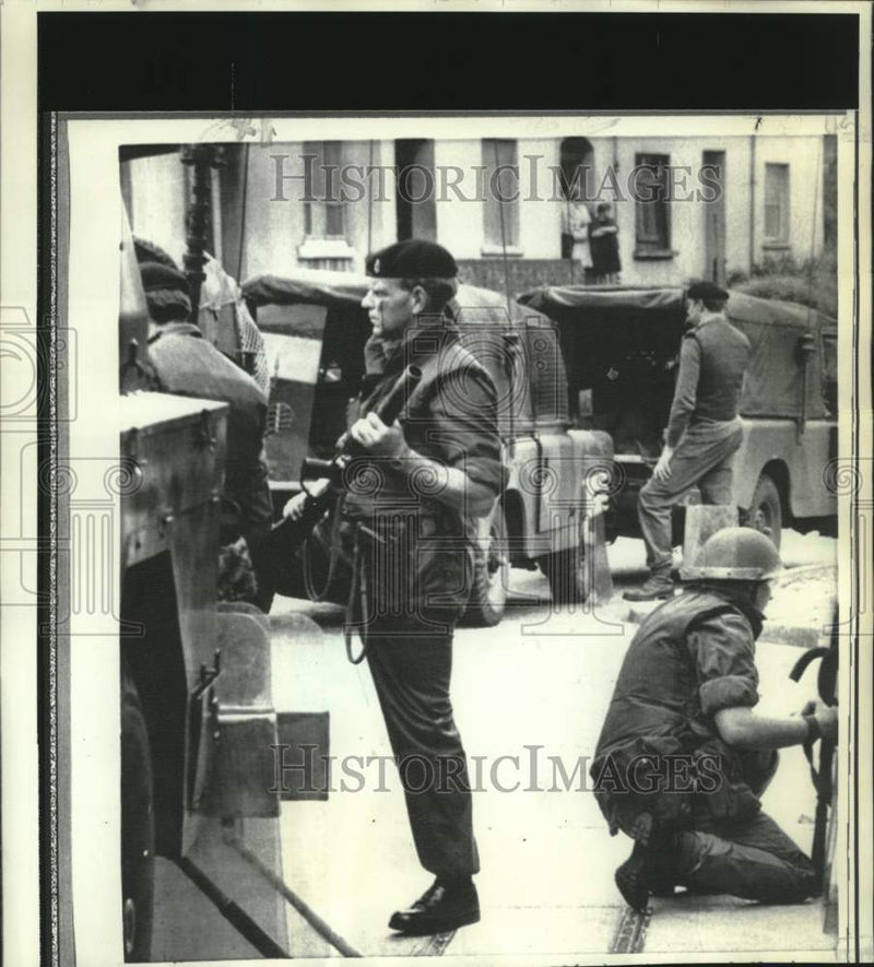 Load image into Gallery viewer, 1971 Press Photo British troops remain on duty during small arms fire.
