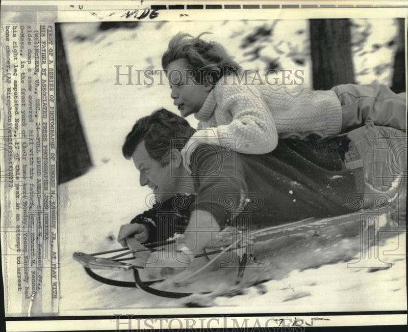 Load image into Gallery viewer, 1973 Press Photo Senator Edward Kennedy and son sled snow covered hill in VA

