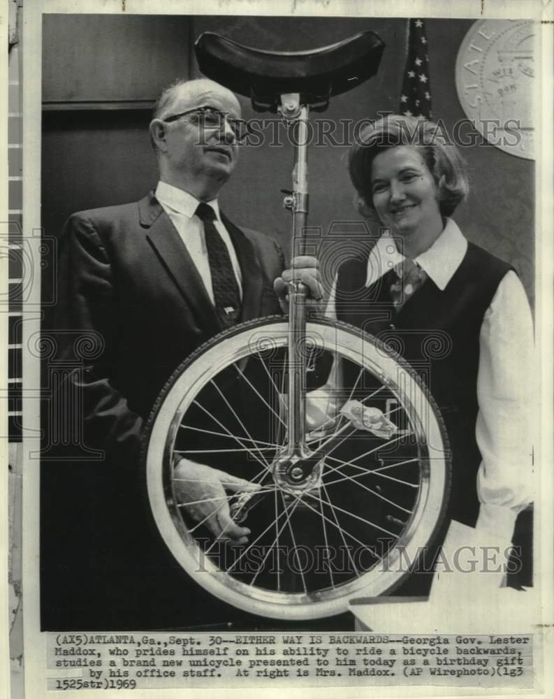 Load image into Gallery viewer, 1969 Press Photo Governor and Mrs.Maddox view unicycle birthday gift - now18907
