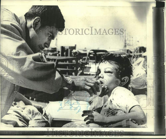 1972 Press Photo Young Managua boy given water at Managua Airport - now21136