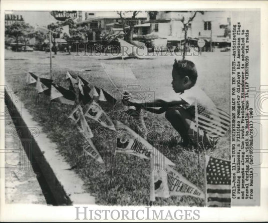 1960 Press Photo Filipino youngster displays American flags on Eisenhower's trip