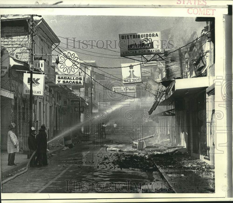 Load image into Gallery viewer, 1972 Press Photo Firemen spray water on smoldering ruins in Managua, Nicargua

