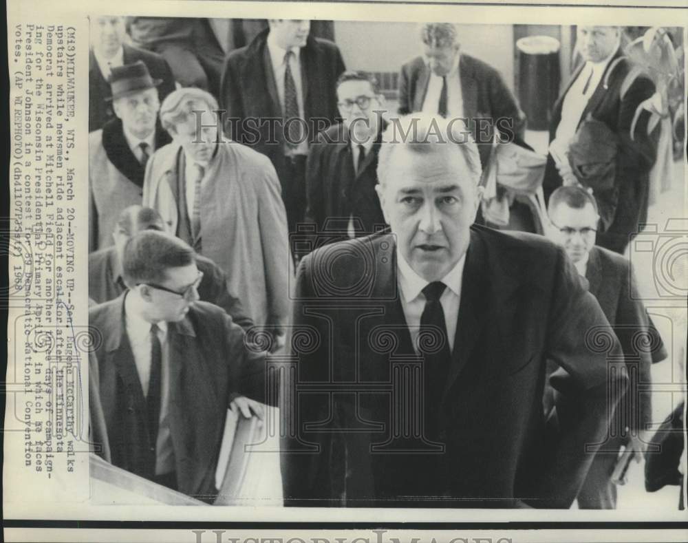 1968 Press Photo Senator McCarthy walks stairs as newsmen ride escalator in WI