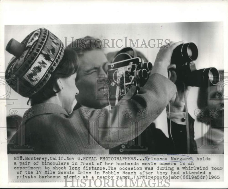 Load image into Gallery viewer, 1965 Press Photo Princess Margaret hold binoculars in front of movie camera
