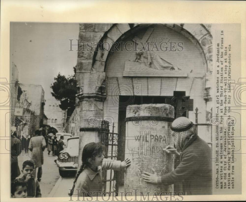 Load image into Gallery viewer, 1964 Press Photo Girl watches Jordanian write welcome message for Pope Paul VI
