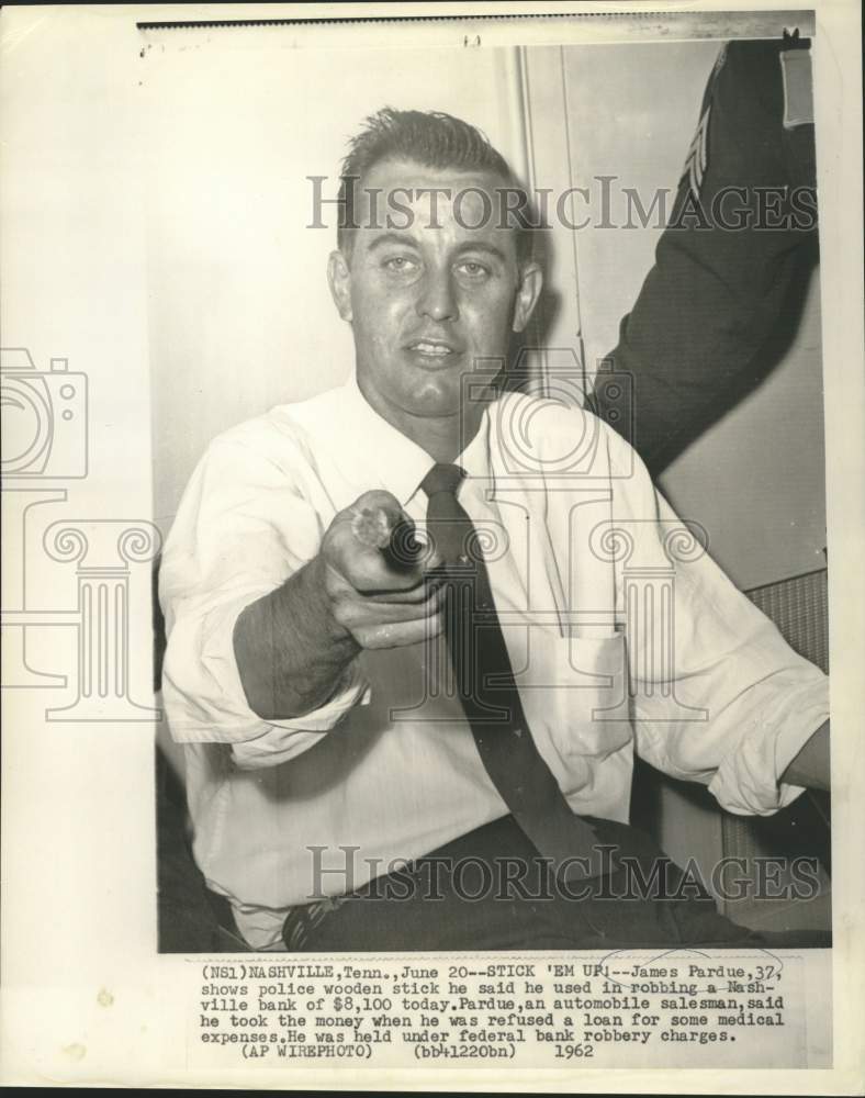 Load image into Gallery viewer, 1962 Press Photo James Pardue shows police wooden stick used in bank robbery

