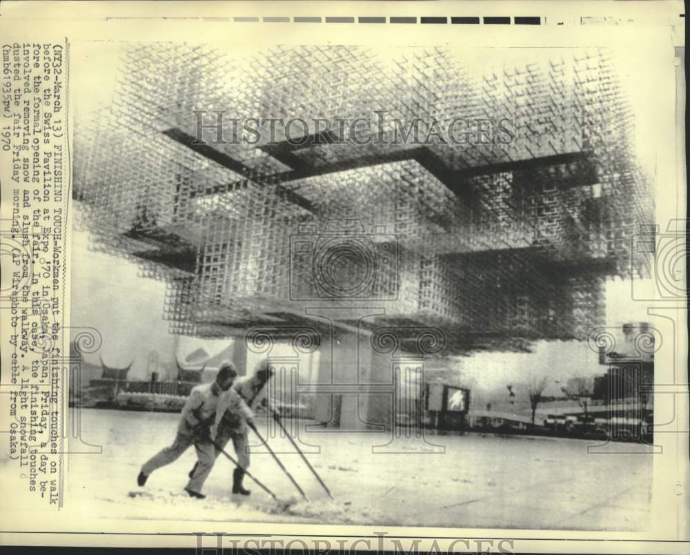 1970 Press Photo Workmen remove snow and slush from Swiss Pavilion at Osaka Expo