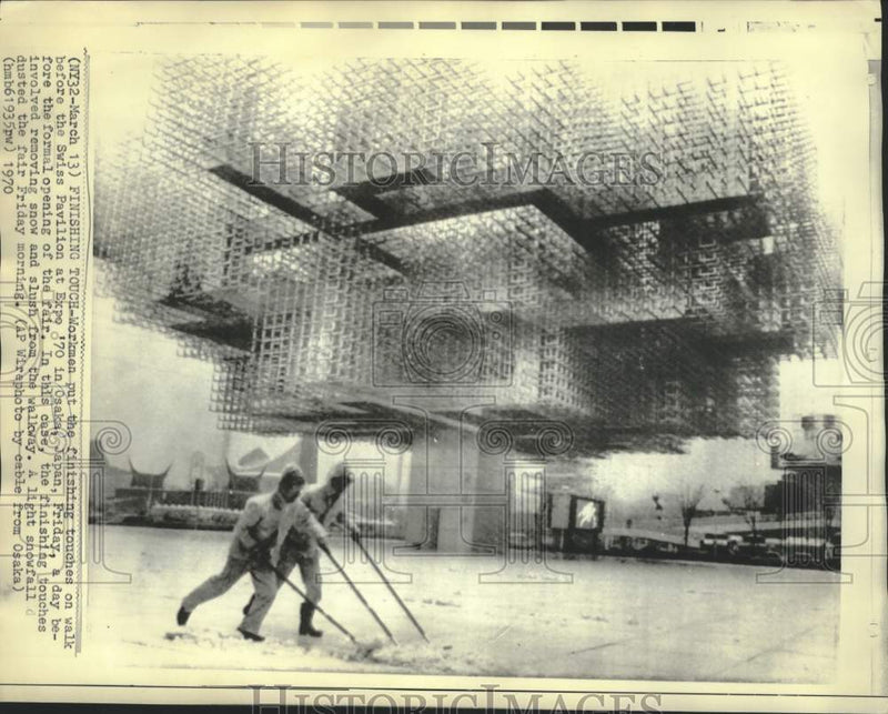 Load image into Gallery viewer, 1970 Press Photo Workmen remove snow and slush from Swiss Pavilion at Osaka Expo
