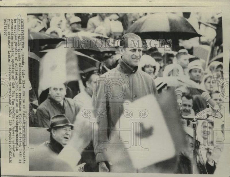 Load image into Gallery viewer, 1967 Press Photo Prince Philip stands in rain at Pan American Games ceremony
