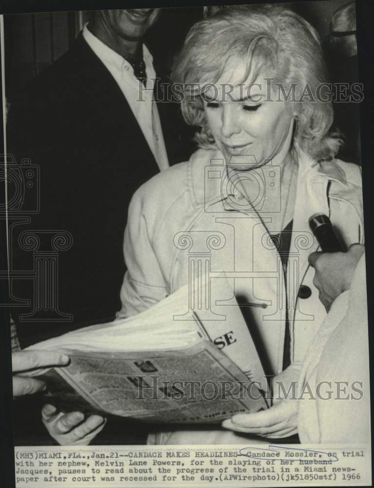 Load image into Gallery viewer, 1966 Press Photo Candace Mossler reads of her murder trial in Miami newspaper
