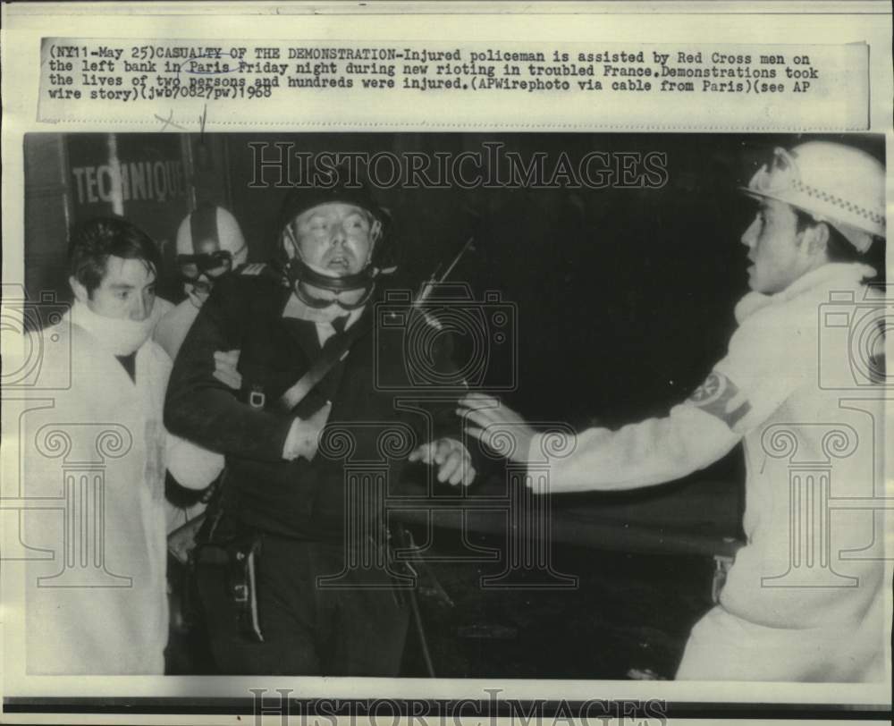 1968 Press Photo Injured policeman assisted by Red Cross during Paris riots