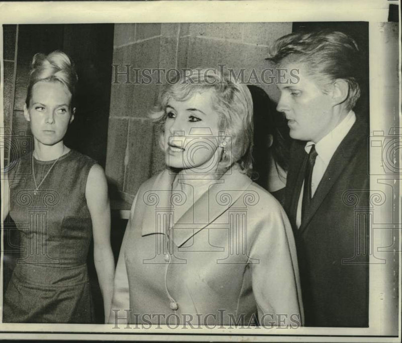 Load image into Gallery viewer, 1966 Press Photo Candace Mossler and family leave Miami, Florida courthouse
