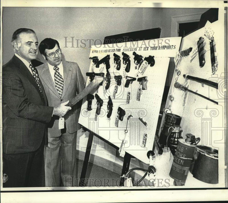 Load image into Gallery viewer, 1972 Press Photo Representative John Murphy with confiscated weapons at airport
