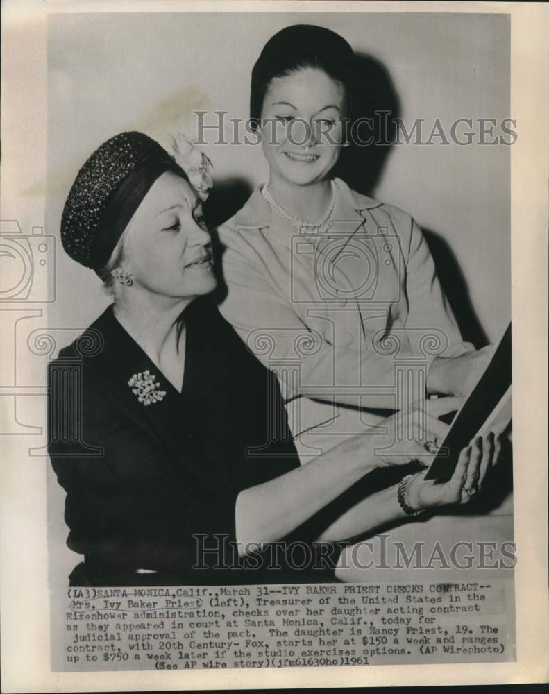 1961 Press Photo Ivy Baker Priest checks daughter&#39;s acting contract, California