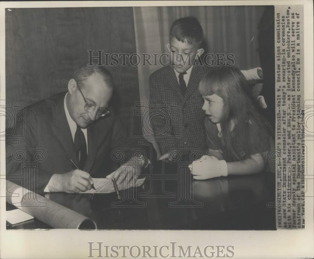 1961 Press Photo State Dept. counselor Walt Rostow signs commission, Washington