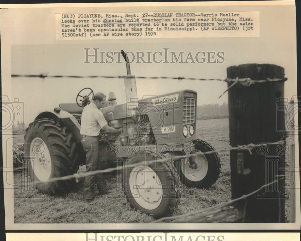 1974 Press Photo Darris Moeller admires his Russian tractor on his farm, MS.