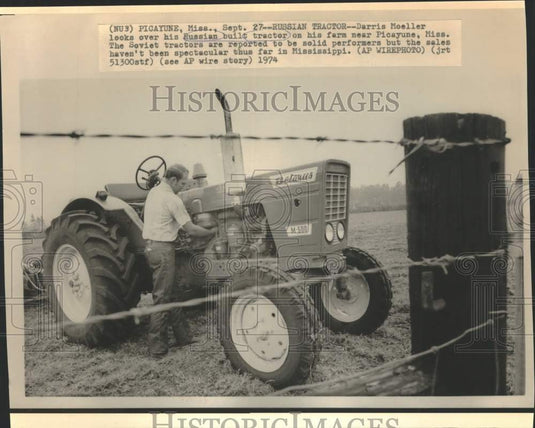1974 Press Photo Darris Moeller admires his Russian tractor on his farm, MS.