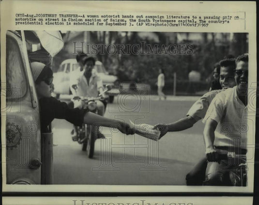 1967 Press Photo Woman Hands Out Campaign Literature in Saigon, South Vietnam