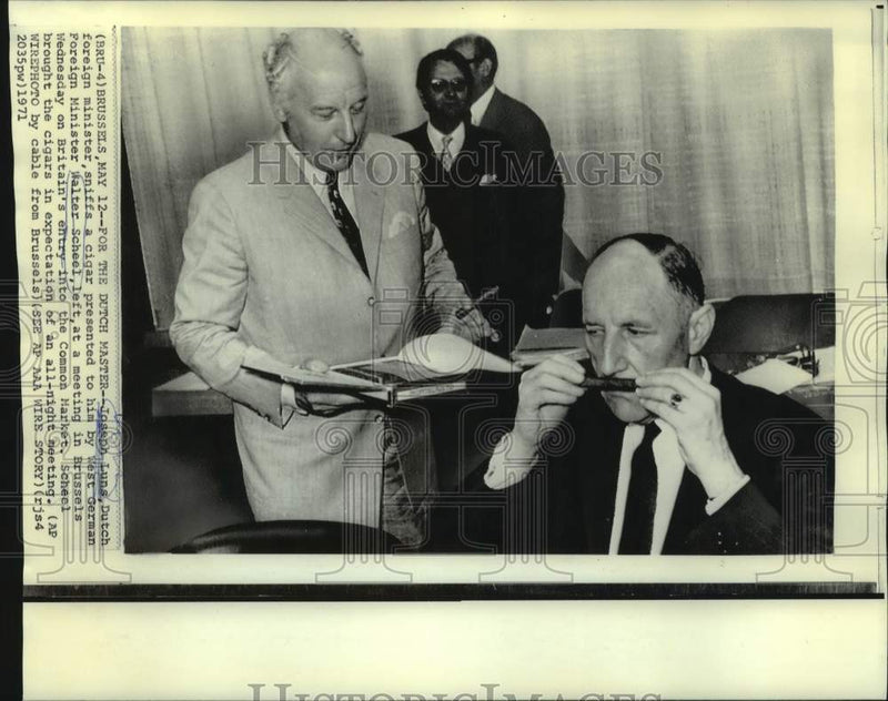 Load image into Gallery viewer, 1971 Press Photo Dutch Foreign Minister Sniffs Cigar at Brussels Meeting
