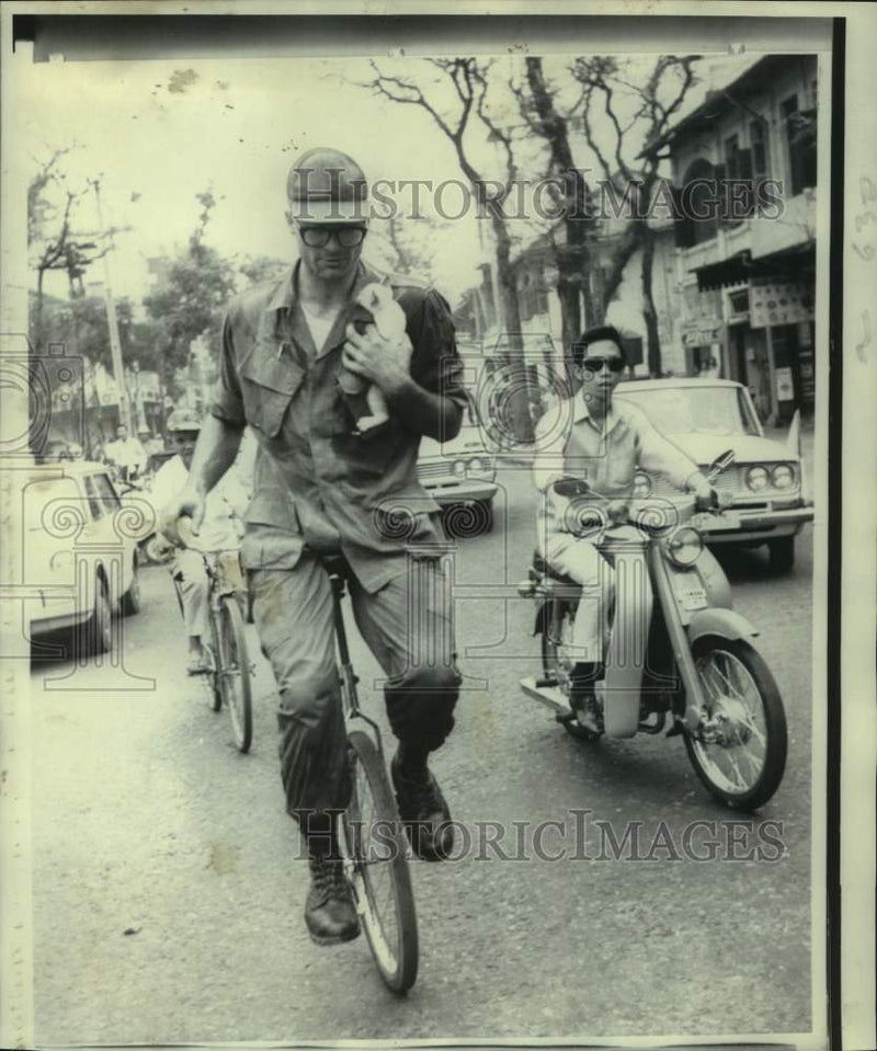 Load image into Gallery viewer, 1969 Press Photo American Soldier James Snipes Rides Unicycle to Work, Saigon
