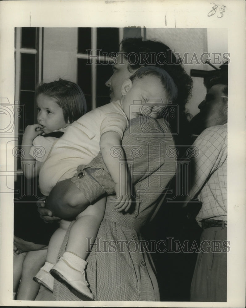 Load image into Gallery viewer, 1950 Press Photo Rene Hidalgo holding nephew James Darby after Carrollton Parade
